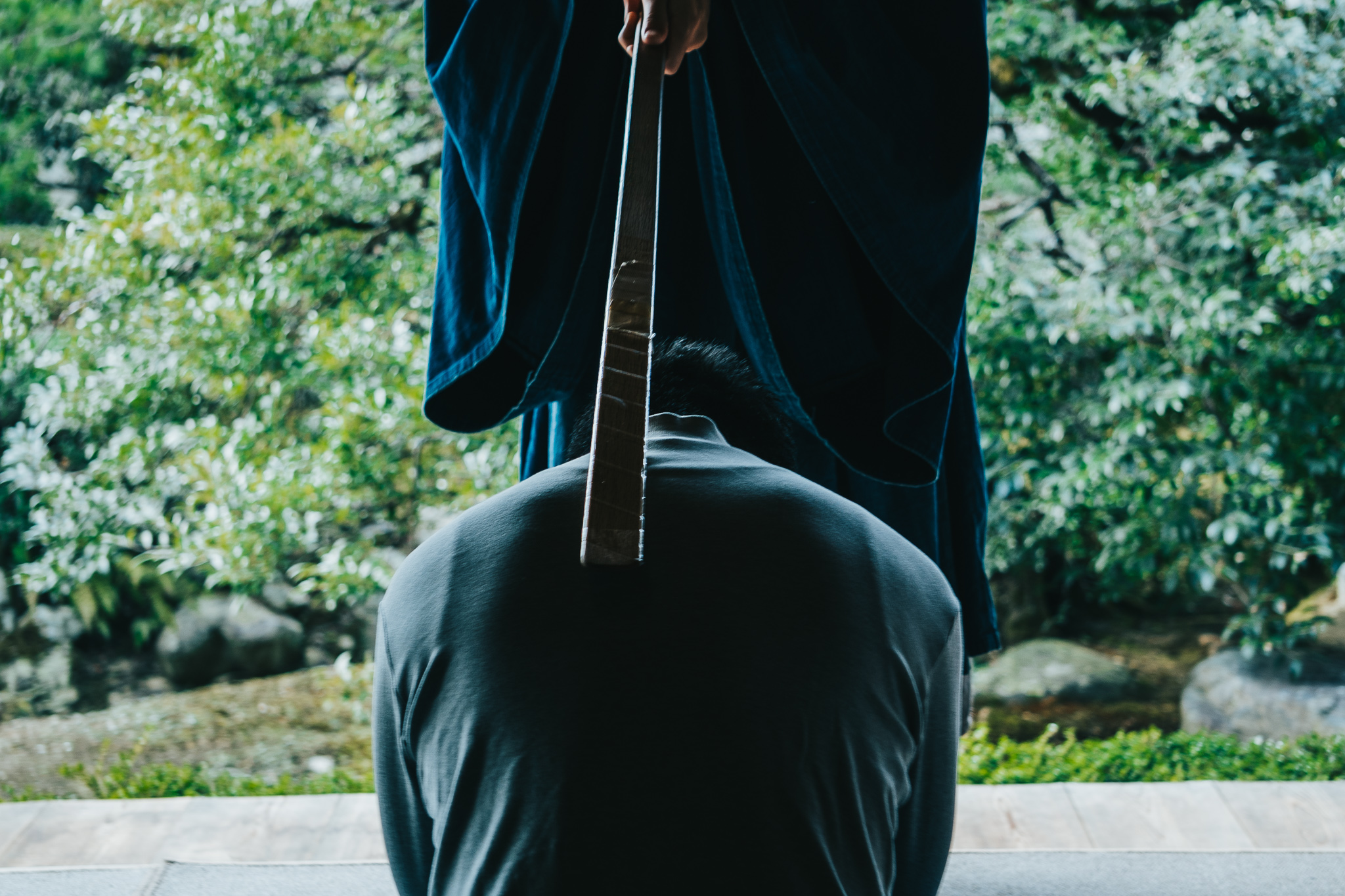 Monk with keisaku stick during zazen session at Jushoin